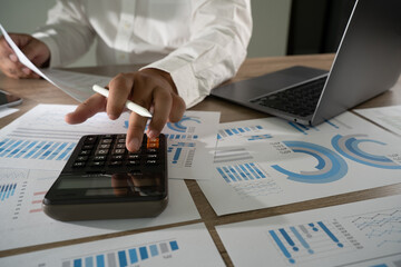 Wall Mural - finances and calculate  businessman finance accountant use calculator and computer report investment economy datum analysis brainstorming new business project finance fund profit concept