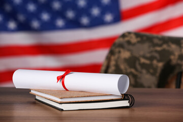 Wall Mural - Diploma and notebooks on wooden table against flag of USA. Military education