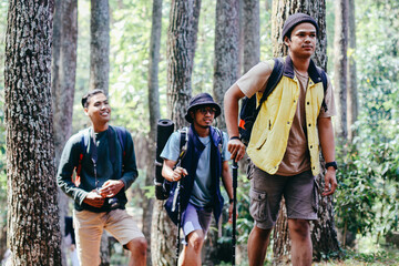group of asian male hiker with backpack and trekking gear, exploring mountain forest. adventure, fri