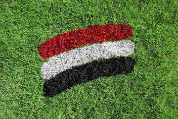 Wall Mural - Yemen flag colors painted on grass field