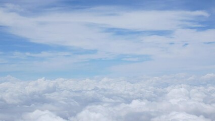 Wall Mural - blue sky with white fluffy clouds from airplane flight fly over the clouds in a sunny day with cloud moving in the atmosphere in hot weather summer time.