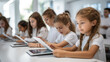 © EmmaStock - the children using education tablet in the classroom