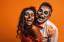 Cheerful Multicultural Couple In Zombie Costumes Joking And Posing On Orange Background