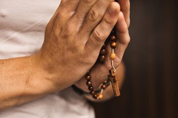 close-up of a Catholic praying with the rosary