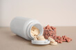 © New Africa - Different pet vitamins on beige table, closeup