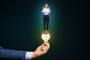 Poster - Business idea, startup and success concept with happy woman on glowing light bulb in man hand on abstract dark background