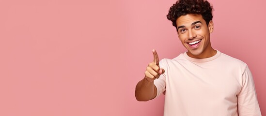 Poster - Confident young Hispanic man pointing in different directions over a pink background
