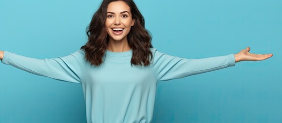 Poster - A happy young woman with open hands is pointing and smiling suggesting an advertisement