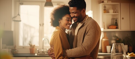 A thankful wife hugs her husband in the kitchen while cooking together