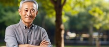 Asian Elderly Man Smiling In Park Korean Pensioner Standing With Arms Crossed Outdoors