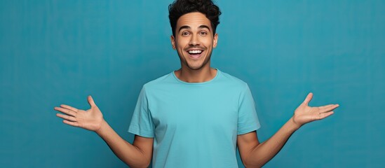 Poster - Smiling Hispanic man pointing with open palms over blue background presenting ad and looking excited