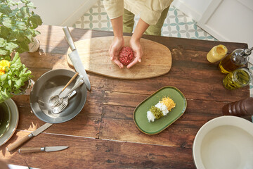 Wall Mural - Crop chief cooking steak tartar in kitchen