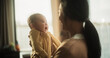 © Gorodenkoff - Motherly Affection Concept: Portrait of a Cute Asian Baby Laughing. Enjoying a Bonding Time with Mother, Looking at her with Love. Woman New to Motherhood Having Special Moment with her Infant