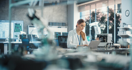 Poster - Portrait of Professional Female Scientist Working in Industrial Lab Using Laptop Computer. Successful Engineer Checking and Monitoring Production Quality, Analysing Data Using Advanced Technology