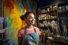 Portrait Of Female Artist Smiling At Camera In Paint Shop At Creative Studio