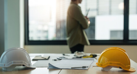 Wall Mural - Engineer working wear worker helmets hardhat on construction site