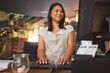 © Azee/peopleimages.com - Restaurant, computer and woman typing order for food service, manage inventory and check sales. Coffee shop, small business and happy waitress, barista or manager by counter on pc for cafe website