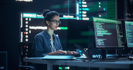 Leinwandbilder - Female Programmer Working in Monitoring Control Room, Surrounded by Big Screens Displaying Lines of Programming Language Code. Portrait of Woman Creating Software. Abstract Futuristic Coding Concept