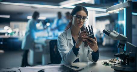 Poster - Portrait of a Young Female Scientist Working in Technological Research and Development Company, Assembling an Innovative Bionic Prosthetic Hand. Engineer Working on Technology for Physically Impaired