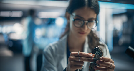 Aufkleber - Focused Professional Female Engineer Working on Electronic Circuit Boards. Industrial Robotics Specialists in Lab Coats Developing a Mobile AI Robot in an Advanced Tech Factory Facility.