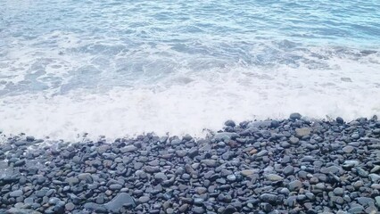 Wall Mural - Foam from crashing waves on rocks and coast