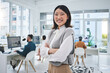 Happy, woman and Asian employee with arms crossed in office, workplace and confident in working for professional startup. Portrait, smile and person with pride and happiness in Singapore business