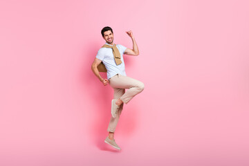 Poster - Full size profile portrait of delighted cheerful man jumping raise fists empty space isolated on pink color background