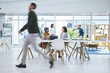 © Azee/peopleimages.com - Business people, walking and busy in meeting, planning and collaboration in office or workspace for startup or project. Professional worker, employees or group in speed or blur for creative teamwork