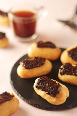 Wall Mural - Traditional French dessert - eclairs with a cup of coffee