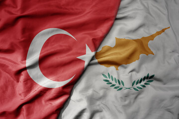 Wall Mural - big waving national colorful flag of turkey and national flag of cyprus .