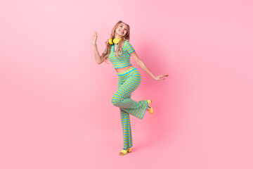 Wall Mural - Full body photo of pretty young girl entertainment dance earphones dressed stylish green print outfit isolated on pink color background