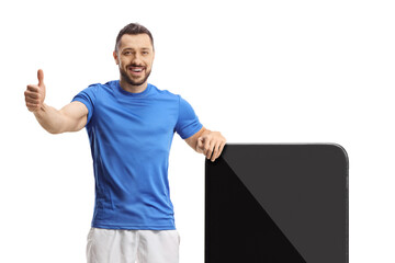 Sticker - Football player standing next to a big smartphone and showing thumbs up