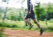 © Sharne/peopleimages.com - Sports man, speed and running in forest with motion blur, cardio workout and exercise action. Runner, fast athlete and training for marathon challenge with energy, dynamic fitness and power in park