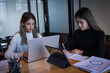 © EduLife Photos - Two female students study together in the library, learning and preparing for university exam