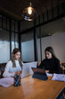 © EduLife Photos - Two female students study together in the library, learning and preparing for university exam