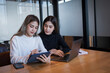 © EduLife Photos - Two female students study together in the library, learning and preparing for university exam