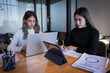 © EduLife Photos - Two female students study together in the library, learning and preparing for university exam