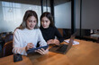 © EduLife Photos - Two female students study together in the library, learning and preparing for university exam