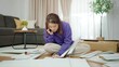 © M Stocker - Young asian woman having problem while assembling furniture by herself. Asian woman talking on mobile phone asking how to assemble furniture. Assembling furniture concept