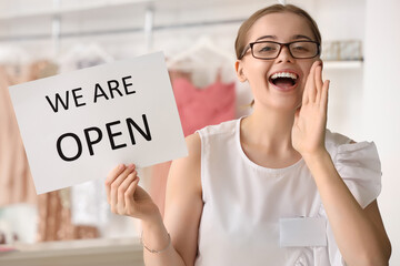 Sticker - Female seller with opening sign in boutique, closeup