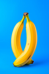 Poster - Fresh yellow bananas on blue background