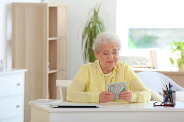 Sticker - Senior woman with money at home