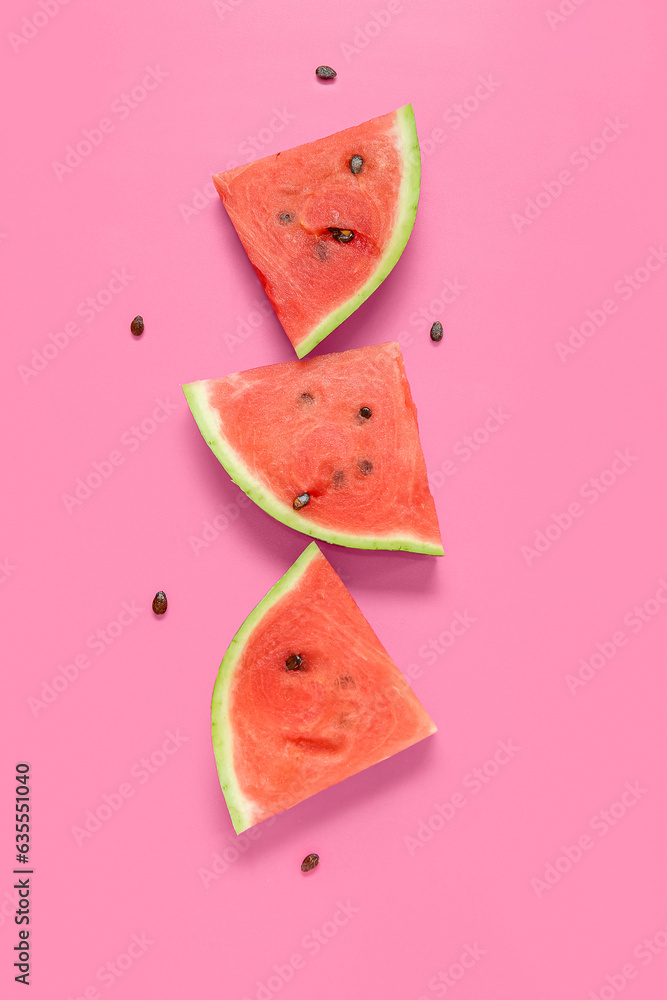 Composition with pieces of ripe watermelon on pink background
