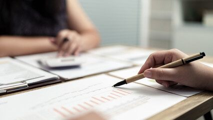 Wall Mural - Business woman analyzing data paperwork calculating numbers.