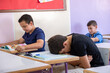 © Viga - Student putting his head on the desk ,looks not feeling well or sleeping
