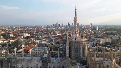 Wall Mural - Europe, Italy, Milan - Aerial view of Piazza Duomo, gothic Cathedral in downtown center city. Drone aerial view of Madonnina statue   and rooftops and new skyline  - Duomo Unesco Heritage sightseeing 