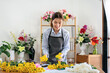 © Katcha - Female florist in apron selecting yellow chrysanthemum to creating and designing floral for arrangement