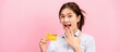 © Katcha - Young asian woman holding credit card and raising one hand to covering mouth while feeling surprised