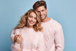 © Surachetsh - Close-up portrait of young loving couple embracing while standing in studio. Couple in athletic sweater. Photo shoot of lovely couple sweater. Generative AI.