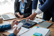 © PaeGAG - Colleagues meeting discuss business project planning, marketing strategies, and financial report analysis for business investment planning.